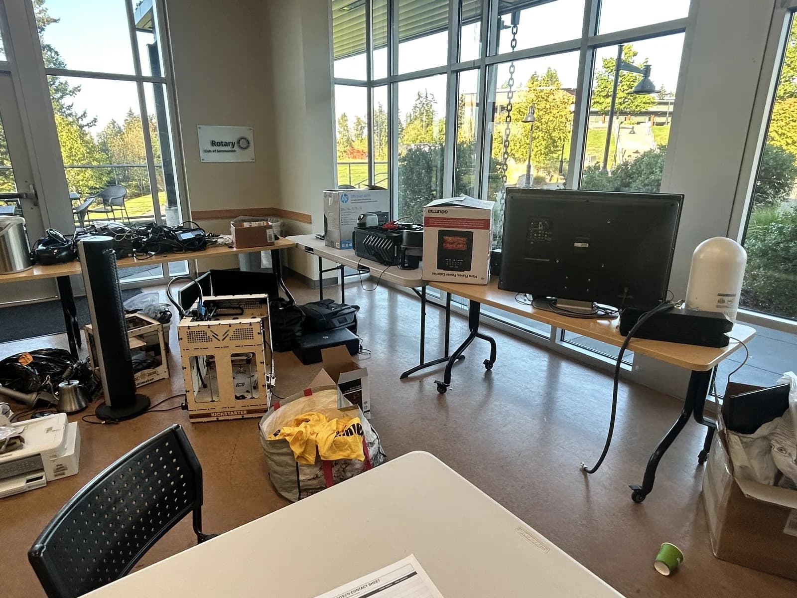 Televisions, small appliances, and other electronics arranged on tables by the YMCA windows