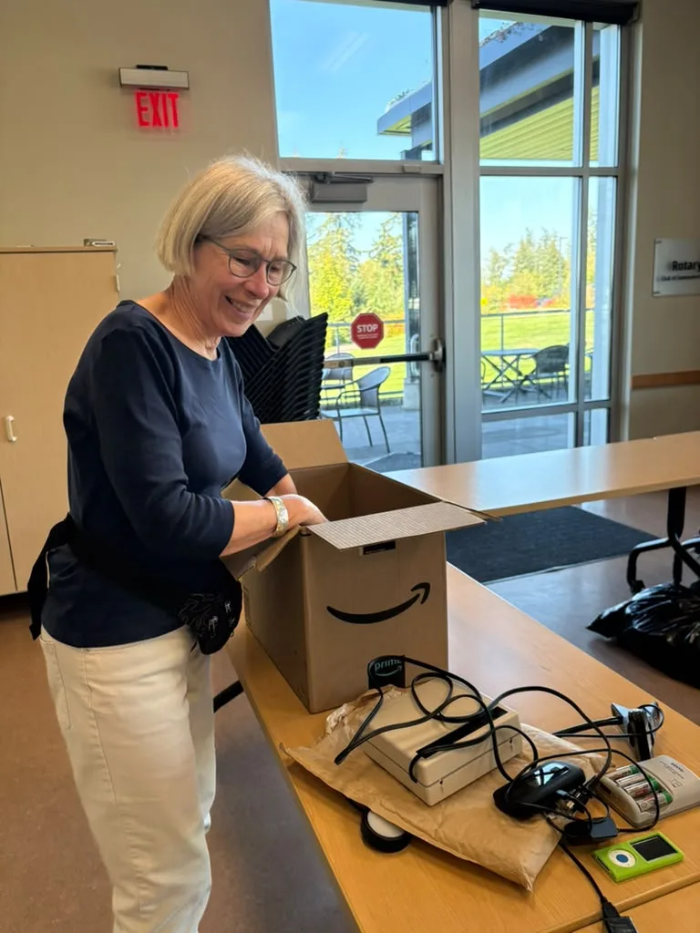 A participant with a box beside donated cables