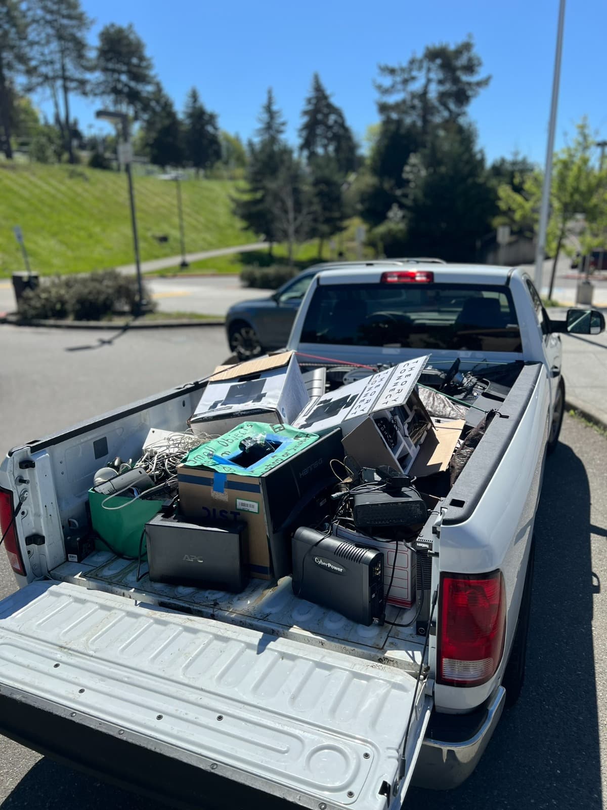 Truck bed loaded with boxed monitors, cables, and other e-waste ready for transport
