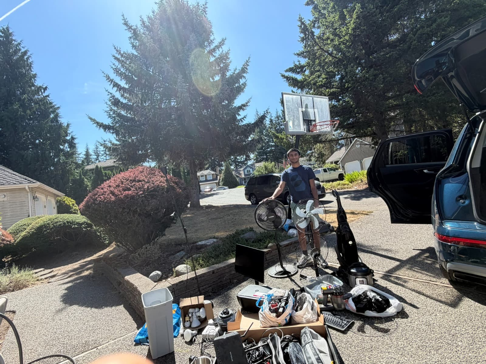 A volunteer beside electronics being prepared for pickup