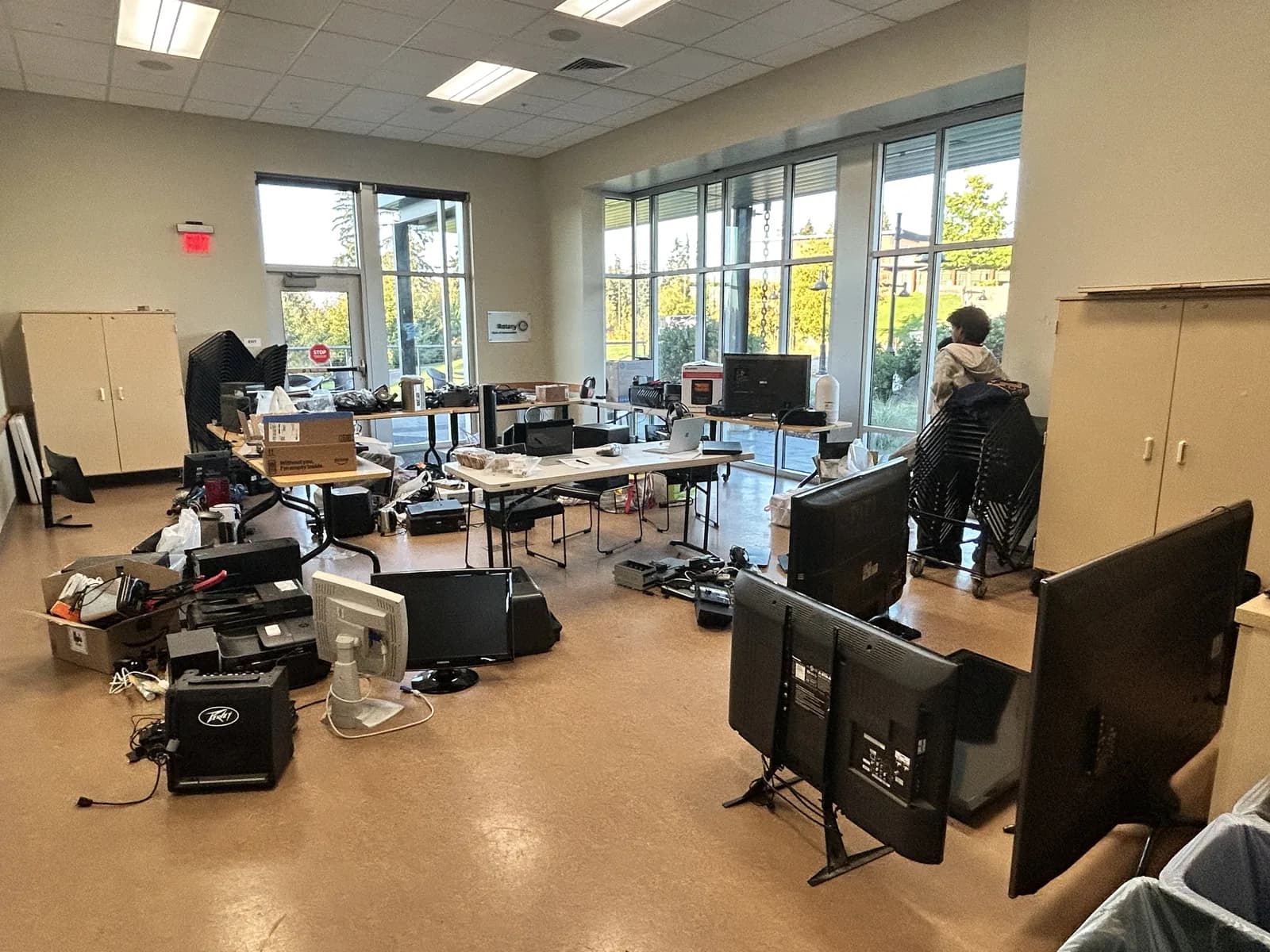 Monitors, computers, and appliances arranged across the YMCA collection room