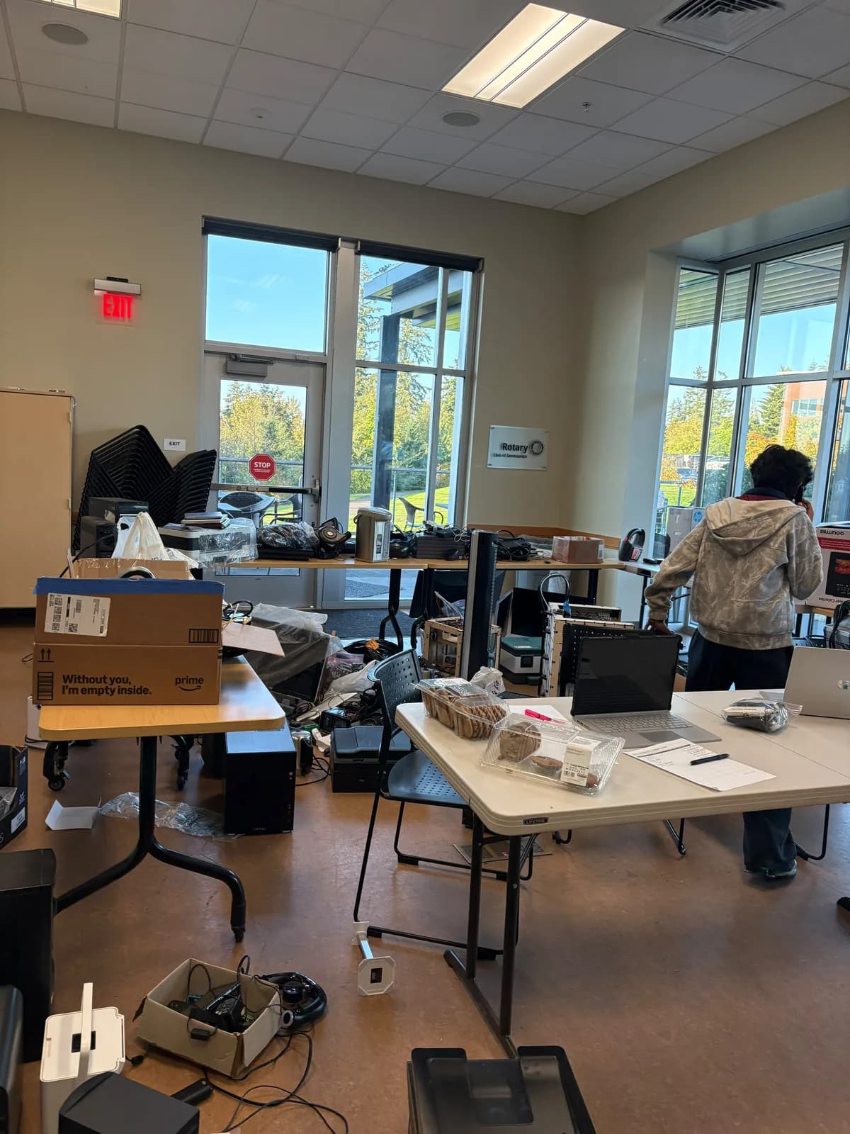Boxes, cables, and electronic devices spread across the collection tables