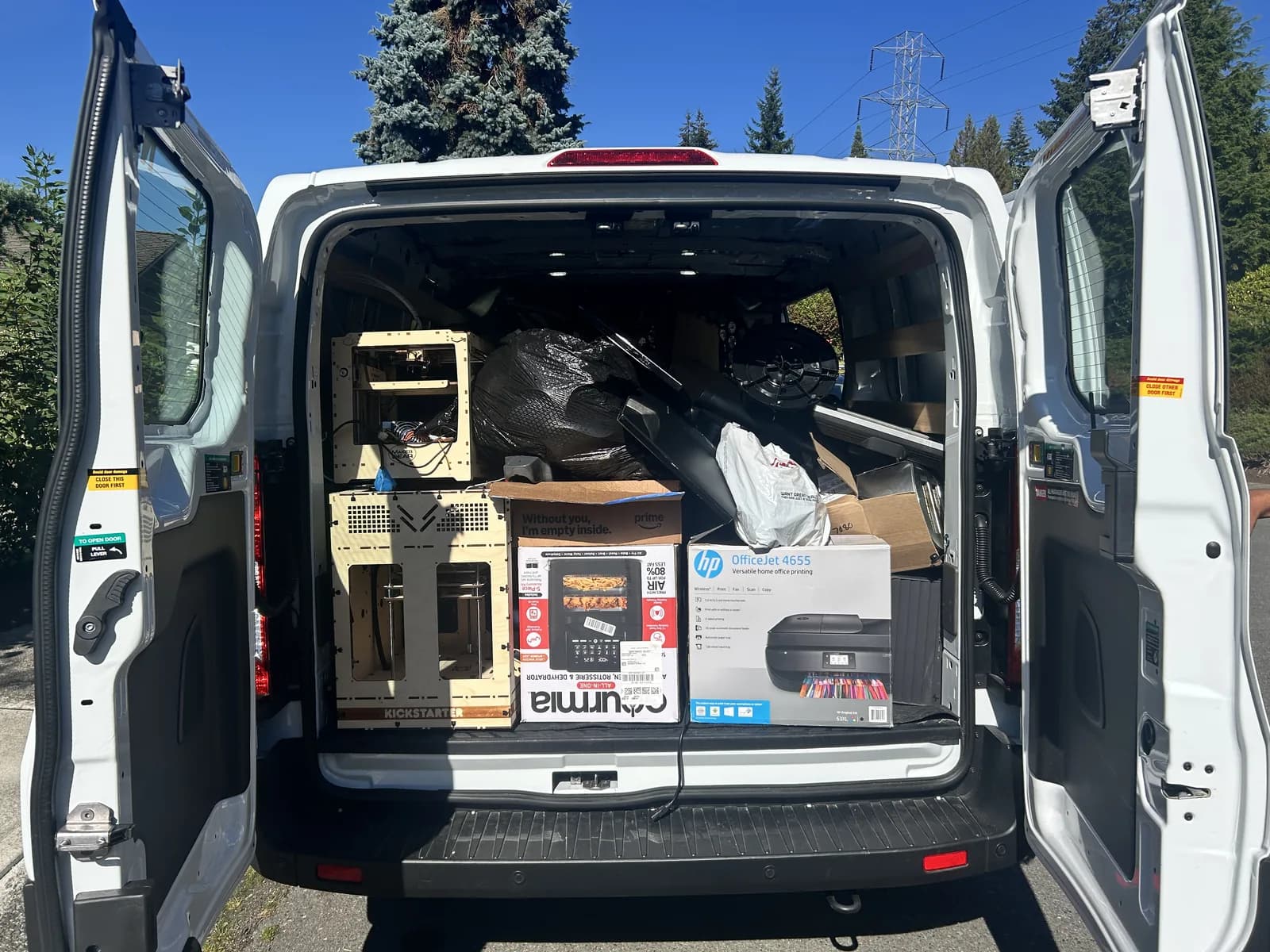 The open rear of a van packed with boxes and collected electronics