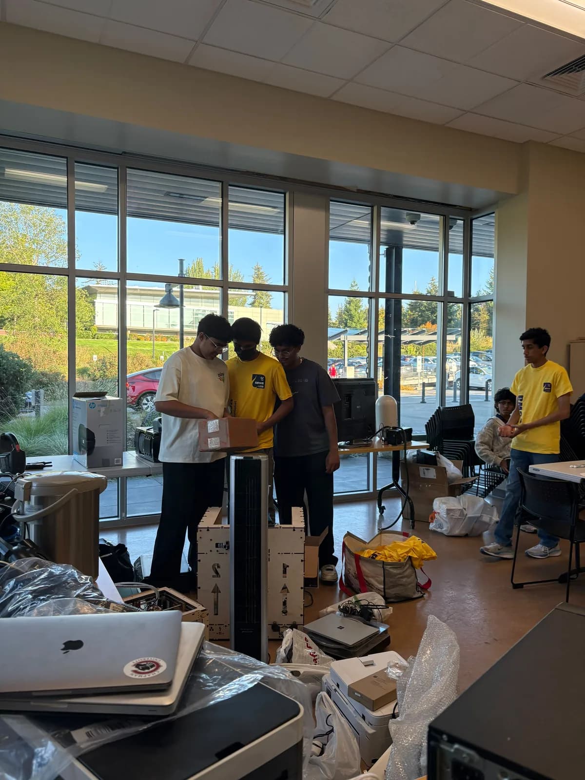 Volunteers sorting donated electronics together at the YMCA collection tables